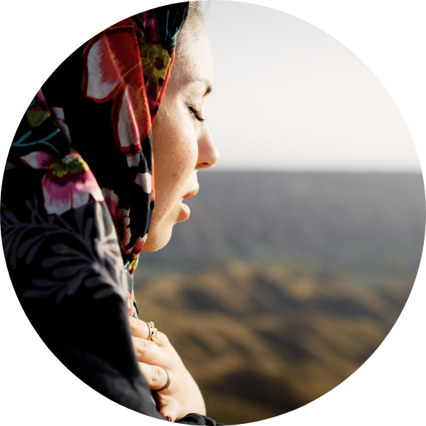 Muslim woman praying outdoors finding spiritual connection.